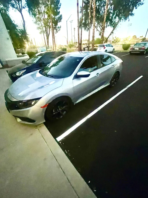Silver Honda Civic with a fresh exterior detail, paint gleaming in the Arizona sun